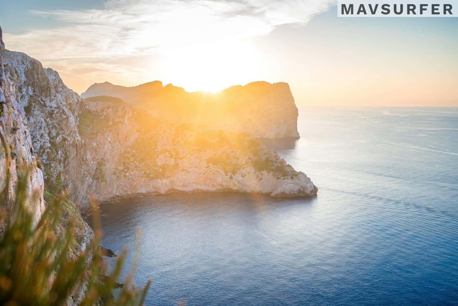 a person standing on a cliff overlooking the ocean