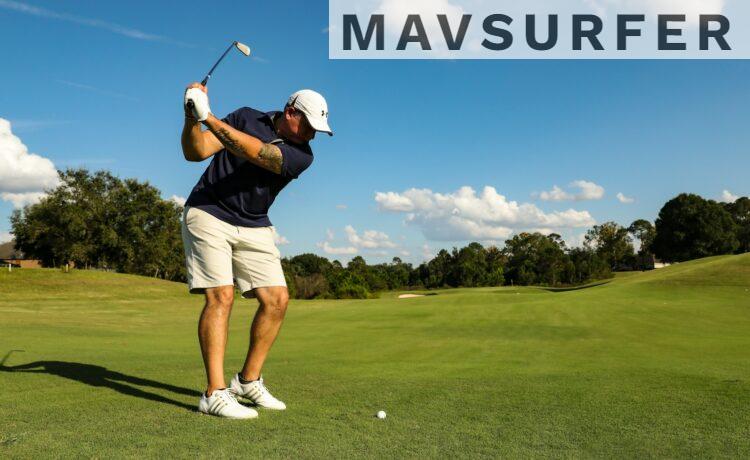 man in black shirt and white shorts playing golf during daytime