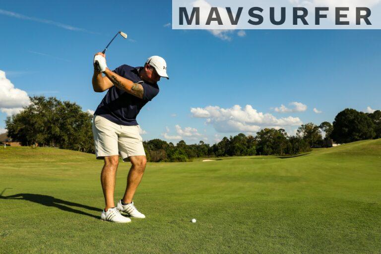 man in black shirt and white shorts playing golf during daytime